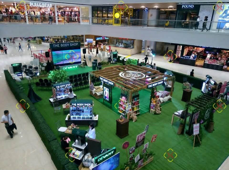 A mall activation with equipment and presentation areas arranged across an atrium